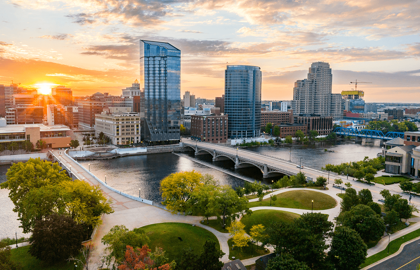 Downtown Grand Rapids skyline at sunset over the Grand River